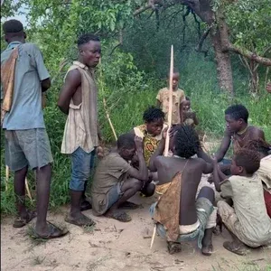 Hadzabe hunters with handmade bows and arrows preparing for the morning hunt near Lake Eyasi